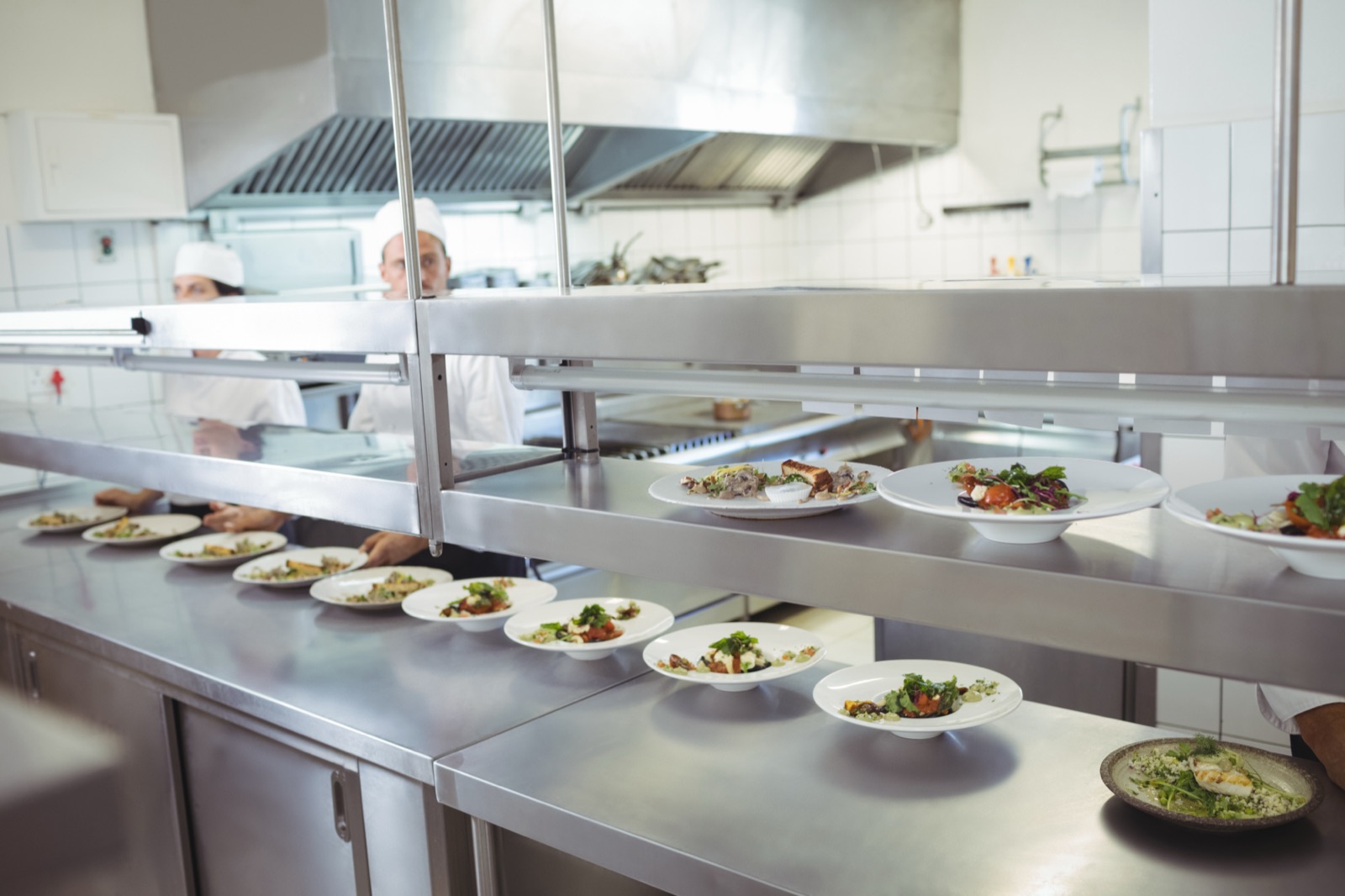 Chefs preparing food at the order station